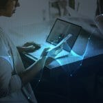 Businesswoman Networking Using Digital Devices 150x150